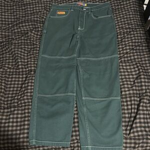 Green colored pants, empyres relax, size 33 waist, White stitching.
